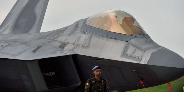 A Romanian army serviceman stands next to an US fight jet F-22 Raptor at the Mihail Kogalniceanu Air Base, near Constanta, Romania, on April 25, 2016. Two F-22 Raptor aircrafts landed on Mihail Kogalniceanu air base as part of the Operation Atlantic Resolve to demonstrate the commitment to the collective security of NATO and dedication to the enduring peace and stability in the region, in light of the Russian intervention in Ukraine specifically. / AFP / DANIEL MIHAILESCU (Photo credit should read DANIEL MIHAILESCU/AFP/Getty Images)