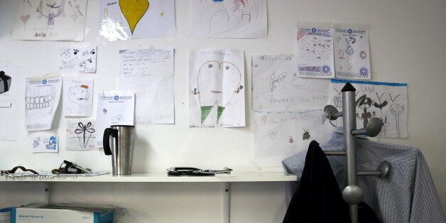 Children's drawings are posted on the wall of the dentist's office at the Doctors of the World polyclinic in central Athens, Greece, October 27, 2015. Picture taken October 27, 2015. To match Special Report GREECE-TEETH/ REUTERS/Alkis Konstantinidis