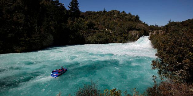 Visitors on a jet boat take in the sights of Taupo's Huka Falls on the Waikato river September 28, 2011. Taupo, known for it's natural scenic beauty and outdoor activities, is one of many New Zealand towns hoping for an economic boost from the 2011 Rugby World Cup. REUTERS/Mike Hutchings (NEW ZEALAND - Tags: TRAVEL SOCIETY)