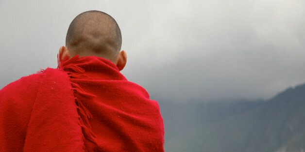 A monk meditates on a mountain in China.