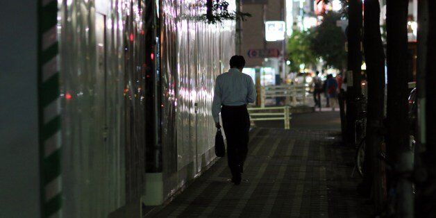 TO GO WITH 'JAPAN-LABOUR-LIFESTYLE-ECONOMY' BY NATSUKO FUKUE This picture taken on May 22, 2015 shows a businessman walking on a street in Tokyo. Japan's push to take away overtime from high-paid workers has critics warning it will aggravate a problem synonymous with the country's notoriously long working hours -- karoshi, or death from overwork. AFP PHOTO / Yoshikazu TSUNO (Photo credit should read YOSHIKAZU TSUNO/AFP/Getty Images)