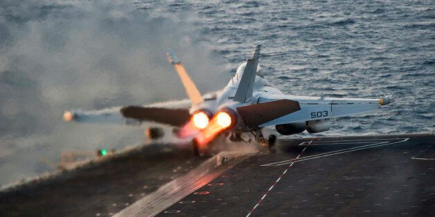 An EA-18G Growler launches from the Nimitz-class aircraft carrier USS Carl Vinson (CVN 70) in this U.S. Navy picture taken in the Arabian Gulf October 28, 2014. The United States targeted Islamic State militants on Sunday and Monday with five air strikes in Syria and nine in Iraq, according to U.S. Central Command. Picture taken October 28, 2014. REUTERS/U.S. Navy/Mass Communication Specialist 2nd Class John Philip Wagner Jr./Handout via Reuters (MID-SEA - Tags: MILITARY CONFLICT TPX IMAGES OF THE DAY) THIS IMAGE HAS BEEN SUPPLIED BY A THIRD PARTY. IT IS DISTRIBUTED, EXACTLY AS RECEIVED BY REUTERS, AS A SERVICE TO CLIENTS. FOR EDITORIAL USE ONLY. NOT FOR SALE FOR MARKETING OR ADVERTISING CAMPAIGNS