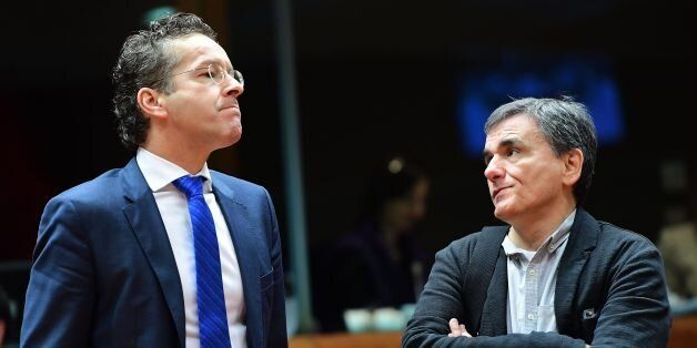 Eurogroup President and Dutch Finance Minister Jeroen Dijsselbloem (L) and Greece's Finance Minister Euclid Tsakalotos attend an Economic and Financial (ECOFIN) Affairs Council meeting at the European Council, in Brussels, on December 6, 2016. / AFP / EMMANUEL DUNAND (Photo credit should read EMMANUEL DUNAND/AFP/Getty Images)
