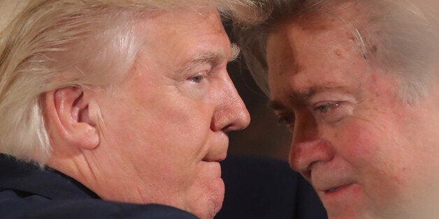 U.S. President Donald Trump talks to senior staff Steve Bannon during a swearing in ceremony for senior staff at the White House in Washington, DC January 22, 2017. REUTERS/Carlos Barria