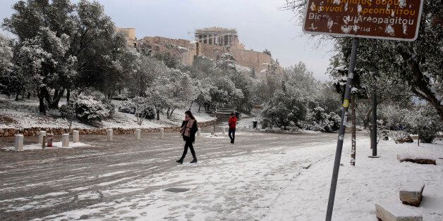 ATHENS, GREECE - JANUARY 10: The Temple of Parthenon on the ancient Acropolis hill is seen following a rare snowfall on January 10, 2017 in Athens, Greece. Schools in Athens remained closed on Tuesday and the rare snowfall caused traffic disruptions in the city centre. (Photo by Milos Bicanski/Getty Images)