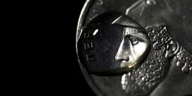 A drop of water is seen on a Greek twenty-Drachma coin depicting ancient Athenian politician and general Pericles in this picture illustration taken in Athens March 22, 2015. REUTERS/Yannis Behrakis