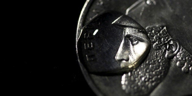 A drop of water is seen on a Greek twenty-Drachma coin depicting ancient Athenian politician and general Pericles in this picture illustration taken in Athens March 22, 2015. REUTERS/Yannis Behrakis