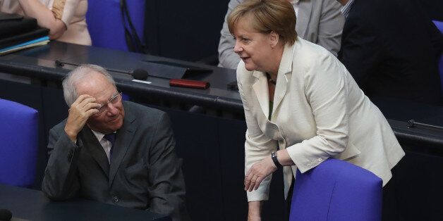 BERLIN, GERMANY - JUNE 28: German Chancellor Angela Merkel speaks with German Finance Minister Wolfgang Schaeuble before she addressed the Bundestag with a government declaration on the recent Brexit vote on June 28, 2016 in Berlin, Germany. European leaders are scheduled to meet at a summit in Brussels later today to discuss the consequences of the British vote to leave the European Union. Merkel called the vote an unprecedented event in EU history but one the remaining 27 member states will weather. (Photo by Sean Gallup/Getty Images)