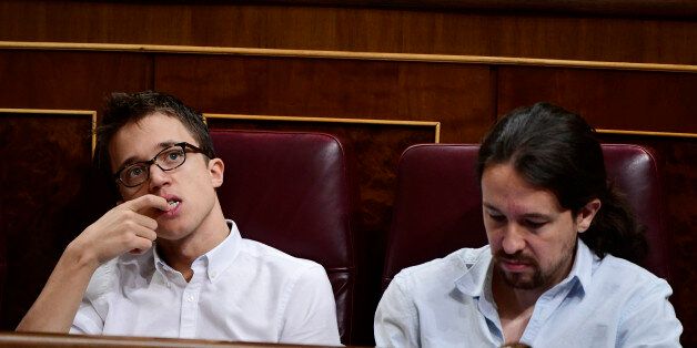 Leader of Podemos Pablo Iglesias (R) and Podemos' spokesman Inigo Errejon attend the second day of the parliamentary investiture debate to vote through a prime minister at the Spanish Congress (Las Cortes) on October 27, 2016, in Madrid.As the conservatives prepare to re-take power in Spain after 10 months of political limbo, anti-austerity party Podemos is bent firmly on replacing the divided Socialists as the main opposition force. / AFP / GERARD JULIEN (Photo credit should read GERARD JULIEN/AFP/Getty Images)