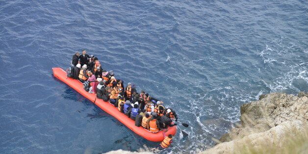 Kas,Turkey - January 16, 2016, Coast line between Kalkan Kas at 09:45. An inflatable boat filled with refugees and other migrants approaches the south coast of the Turkey. Picture captured from Kalkan Kas Road D400.