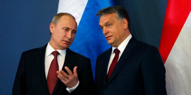 Russian President Vladimir Putin and Hungarian Prime Minister Viktor Orban (R) arrive for a joint news conference in Budapest February 17, 2015. Putin will discuss Russian gas supplies to Hungary when he visits Budapest on Tuesday, an adviser to the Russian president said on Monday. REUTERS/Laszlo Balogh (HUNGARY - Tags: POLITICS)