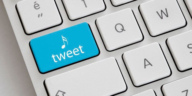 Blue coloured 'Tweet' button on a keyboard.