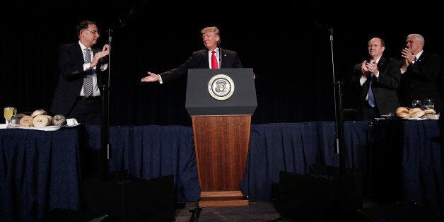 U.S. President Donald Trump, center, gestures during the National Prayer Breakfast in Washington, D.C., U.S., on Thursday, Feb. 2, 2017. For the first time in decades, America's oldest allies are questioning where Washington's heart is. 'The world is in trouble -- but we're going to straighten it out, ok? That's what I do,' Trump said to an audience of religious and political leaders at the National Prayer Breakfast. Photographer: Win McNamee/ Pool via Bloomberg