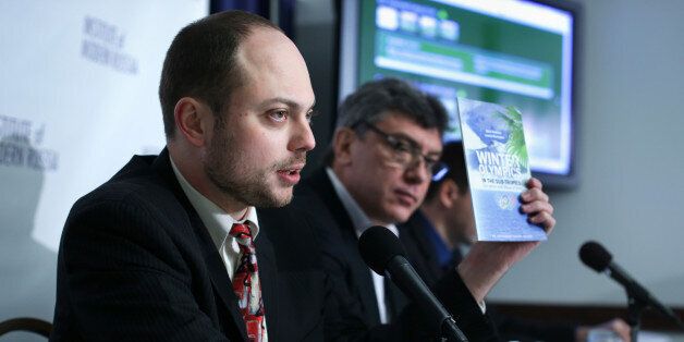 WASHINGTON, DC - JANUARY 30: Vladimir Kara-Murza (L), senior policy adviser at the Institute of Modern Russia, holds up a copy of the report on 'Winter Olympics in the Sub-Tropics' as Russian opposition leader and former Deputy Prime Minister Boris Nemtsov (R) listens during a news conference on 'Corruption and Abuse in Sochi Olympics' January 30, 2014 at the National Press Club in Washington, DC. The Institute of Modern Russia held the news conference to launch a new online interactive 'corruption guide' to the Sochi Olympics and the release of the report which conducted by Nemtsov and Leonid Martynyuk, Russian journalist and opposition activist from the Krasnodar region. (Photo by Alex Wong/Getty Images)
