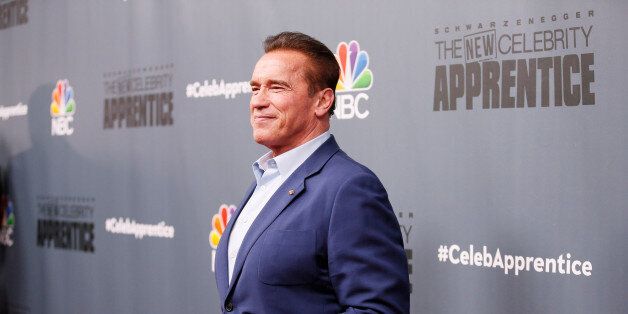 Host Arnold Schwarzenegger poses after a panel for