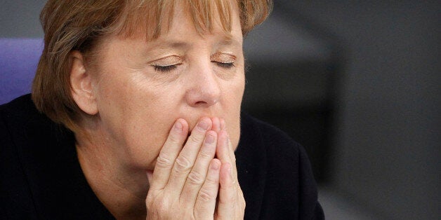 German Chancellor Angela Merkel (foreground C) listens to a budget debate in the Bundestag, the German lower house of parliament in Berlin, September 7, 2011. REUTERS/Thomas Peter (GERMANY - Tags: POLITICS TPX IMAGES OF THE DAY)