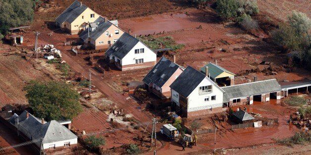 An aerial photo taken on October 8, 2010 shows a part of the village of Kolontar, nearby Torna stream, some 160 kilometers southwest of Hungarian capital Budapest. Wave of toxic red mud of the Ajkai Timfoldgyar plant swept through the small village five days ago, killing five and injuring scores more. The accident -- which officials say is Hungary's worst-ever chemical accident and an 'ecological disaster' -- occurred on October 4 when the walls of a reservoir of residue at an aluminium plant in nearby Ajka broke, sending a wave of stinking red sludge through seven villages in the west of the country and leaving a trail of devastation across an area of 40 square kms (15.4 square miles). In Kolontar, the army had to build a temporary bridge to replace one that was swept away by the flood. AFP PHOTO / STR (Photo credit should read STR/AFP/Getty Images)