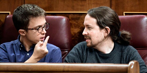 Podemos' leader Pablo Iglesias (R) looks at Podemos' representative Inigo Errejon at the Spanish Congress (Las Cortes) on October 26, 2016, in Madrid during the first day of the parliamentary investiture debate to vote through a prime minister.Spain's acting Prime Minister Mariano Rajoy warned of a tough road ahead today as he prepares to take power again at the head of a minority government with very little support. / AFP / JAVIER SORIANO (Photo credit should read JAVIER SORIANO/AFP/Getty Images)