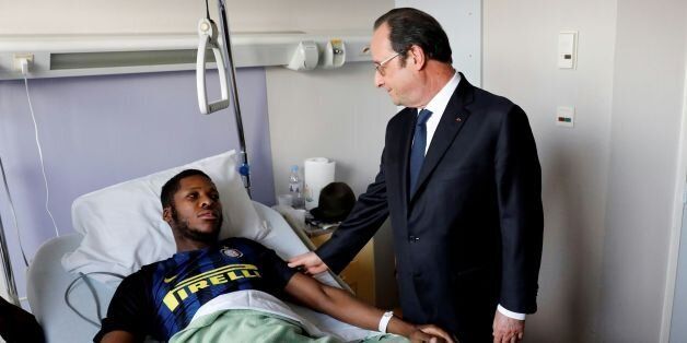 TOPSHOT - In this picture taken on February 7, 2017 at the Robert Ballanger in Aulnay-sous-Bois suburban Paris, French President Francois Hollande (R) visits a youth worker identified only as Theo, who required major surgery after his arrest, when he claims a police officer sodomized him with his truncheon. The case of the man identified only as Theo, who was sent to hospital with severe anal injuries and head trauma, threatens to revive the contentious issue of policing in France's poor suburbs, which saw the death in custody of another black man last year and major riots a decade ago. / AFP / LE PARISIEN / Arnaud Journois / RESTRICTED TO EDITORIAL USE (Photo credit should read ARNAUD JOURNOIS/AFP/Getty Images)