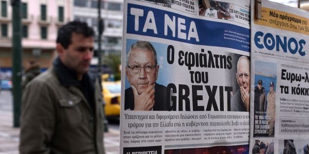 A man looks at newspapers bearing headlines reading 'The nightmare of Grexit' on January 31, 2017. / AFP / LOUISA GOULIAMAKI (Photo credit should read LOUISA GOULIAMAKI/AFP/Getty Images)