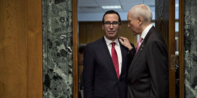 Steven Mnuchin, Treasury secretary nominee for president-elect Donald Trump, left, and Senator Orrin Hatch, a Republican from Utahn and chairman of the Senate Finance Committee, arrive to a Senate Finance Committee confirmation hearing in Washington, D.C., U.S., on Thursday, Jan. 19, 2017. Mnuchin defended his record as an owner of a mortgage lender that was accused of unfair loan and foreclosure practices during the financial crisis. Photographer: Andrew Harrer/Bloomberg via Getty Images