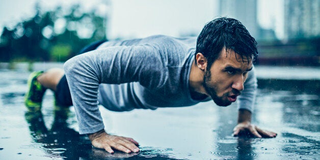 Picture of a young athletic man out exercising in the rain