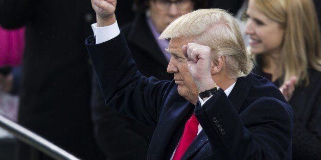 WASHINGTON, USA - JANUARY 20: President Donald Trump raises his fists to the crowds during the 58th U.S. Presidential Inauguration after he was sworn in as the 45th President of the United States of America in Washington, USA on January 20, 2017. (Photo by Samuel Corum/Anadolu Agency/Getty Images)