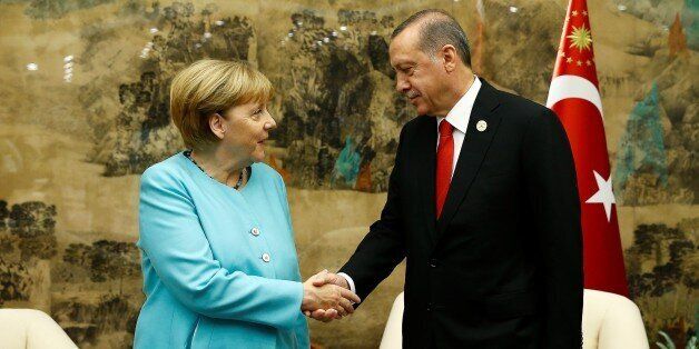 HANGZHOU, CHINA - SEPTEMBER 04: Turkish President Recep Tayyip Erdogan (R) shakes hands with German Chancellor Angela Merkel (L) before their meeting as the 11th G20 Leaders' Summit continues in Hangzhou, China, on September 04, 2016. (Photo by Mehmet Ali Ozcan/Anadolu Agency/Getty Images)