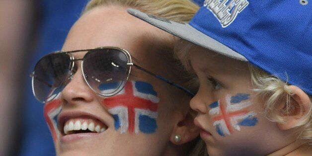 An Iceland's supporter and her child are pictured ahead of the Euro 2016 group F football match between Iceland and Hungary at the Stade Velodrome in Marseille on June 18, 2016. / AFP / BORIS HORVAT (Photo credit should read BORIS HORVAT/AFP/Getty Images)