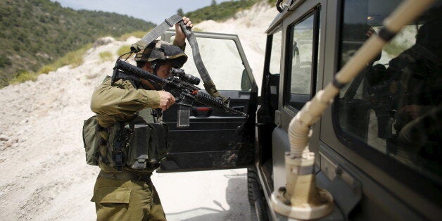 Israeli Defence Forces (IDF) Lieutenant-General Eli David, enters a jeep during an observation of the area where the Israeli army is excavating part of a cliff to create an additional barrier along its border with Lebanon, near the community of Shlomi in northern Israel April 6, 2016. IDF Lieutenant-General Eli David, who serves as an engineering officer in a northern division, told Reuters on Wednesday that the army began work on the new barrier by exposing the cliff in January 2015, to help protect communities located close to the Lebanese border from infiltrators. REUTERS/Ronen Zvulun