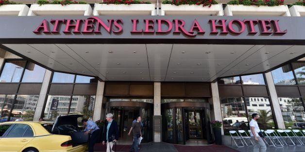 Customers leave the luxury Athens Ledra Hotel following its closure on June 2, 2016. The Athens central Athens Ledra Hotel, announced the closure of the 314-room establishment, citing 'financial difficulties'. More than 150 Athens Ledra employees have not been paid since March. / AFP / LOUISA GOULIAMAKI (Photo credit should read LOUISA GOULIAMAKI/AFP/Getty Images)