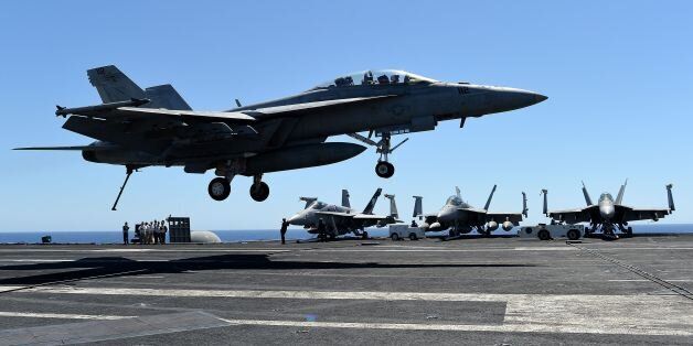 An F/A-18F Super Hornet lands on the US navy's super carrier USS Dwight D. Eisenhower (CVN-69) ('Ike') in the Mediterranean Sea on July 6, 2016.The US aircraft carrier is deployed in support of Operation Inherent Resolve, maritime security operations and theater security cooperation efforts in the US 6th Fleet area of operations. Air Wings embarked aboard conducted strikes against the Islamic State group in Libya , Iraq and Syria. / AFP / ALBERTO PIZZOLI (Photo credit should read ALBERTO PIZZOLI/AFP/Getty Images)