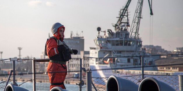 A soldier stands guard on the Turkish boat TCG Turgutreis in the port of Varna, March 9, 2015. NATO ships arrived in the Bulgarian port city of Varna on Sunday on a scheduled visit during a joint exercise in the Black Sea, the alliance said. The group, comprised of six American, Canadian, Turkish, German, Italian and Romanian ships, entered the Black Sea earlier this month, and is expected to do scheduled training with ships from the Bulgarian, Romanian and Turkish navies. The exercises will be held just across the water from the Crimean Peninsula, which was annexed by Russia in March 2014 and where Russian military groups have seized control from Ukrainian authorities. REUTERS/Sasa Kavic (BULGARIA - Tags: MILITARY POLITICS)