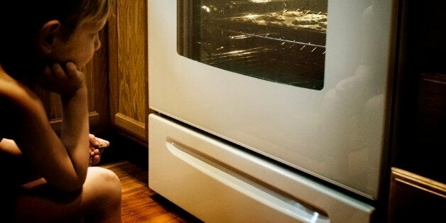 Boy waiting baked chocolate chip cookies.