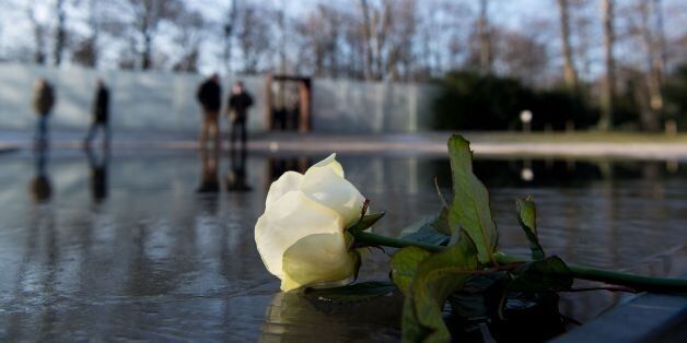 A white rose lays at Berlin's Memorial to the Sinti and Roma Victims of National Socialism during a commemoration ceremony on January 27, 2017, the International Holocaust Remembrance Day. / AFP / dpa / Monika Skolimowska / Germany OUT (Photo credit should read MONIKA SKOLIMOWSKA/AFP/Getty Images)