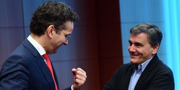 Eurogroup President and Dutch Finance Minister Jeroen Dijsselbloem (L) and Greece's Finance Minister Euclid Tsakalotos speak together ahead of a Eurogroup finance ministers meeting at the European Council in Brussels, on December 5, 2016. / AFP / EMMANUEL DUNAND (Photo credit should read EMMANUEL DUNAND/AFP/Getty Images)