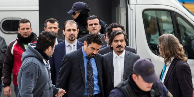 The eight Turkish soldiers, who fled to Greece in a helicopter and requested political asylum after a failed military coup against the government, are escorted by police officers as they arrive at the Supreme Court in Athens, Greece, January 26, 2017. REUTERS/Alkis Konstantinidis