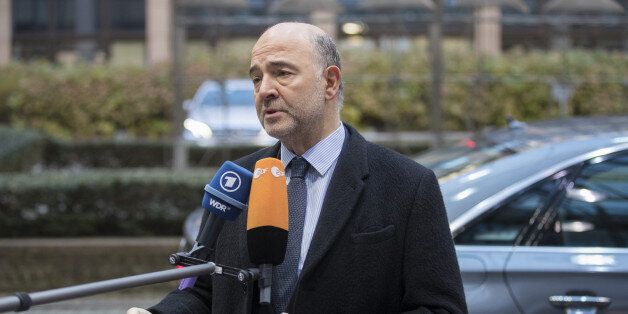 Pierre Moscovici, economic commissioner for the European Union (EU), speaks to members of the media as he arrives ahead of a Eurogroup meeting of European finance ministers in Brussels, Belgium, on Monday, Dec. 5, 2016. Since Greece's debt triggered a wave of shocks that spooked investors in Europe more than six years ago, EU governments -- led by Angela Merkel's Germany, the bloc's largest economy -- have been pursuing an austerity-first agenda; not only raising taxes, slashing spending and striving to narrow deficits themselves but demanding other nations do likewise. Photographer: Jasper Juinen/Bloomberg via Getty Images