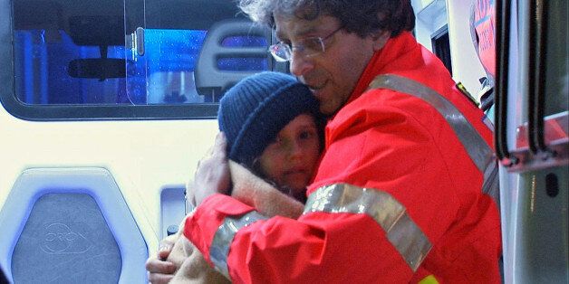 A still image taken from a video shows a child rescued from the Hotel Rigopiano in the arms of a rescue worker as she arrives by helicopter in the city of Pescara, Italy January 20, 2017. Video taken january 20, 2017. REUTERS/via Reuters TV ATTENTION EDITORS - ITALIAN LAW REQUIRES THAT THE FACES OF MINORS ARE MASKED IN PUBLICATIONS WITHIN ITALY TPX IMAGES OF THE DAY