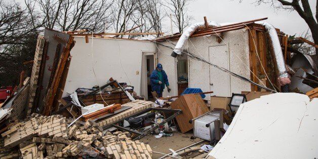 A heavily damaged residence is seen December 27, 2015 in the aftermath of a tornado in Rowlett, Texas. At least 11 people lost their lives as tornadoes tore through Texas, authorities said, as they searched home to home for possible more victims of the freak storms lashing the southern United States. The rare December twisters that flattened houses and caused chaos on highways raised the death toll from days of deadly weather across the South to at least 28. AFP PHOTO/LAURA BUCKMAN / AFP / LAURA BUCKMAN (Photo credit should read LAURA BUCKMAN/AFP/Getty Images)