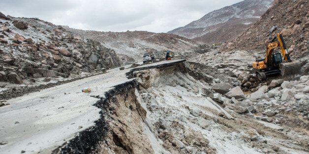View of the Peruvian Panamerican highway after a landslide in Arequipa, southern Peru, on January 27, 2017.Floods and landslides in Peru have killed four people and displaced more than 11,000 families over recent weeks, the authorities said Friday. Three people drowned when their vehicle was caught in a flood in the southern Arequipa region, the National Civil Defense Institute said. / AFP / Ernesto BENAVIDES (Photo credit should read ERNESTO BENAVIDES/AFP/Getty Images)