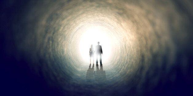 A shot of two people finding an exit from a dark tunnel - ALL design on this image is created from scratch by Yuri Arcurs' team of professionals for this particular photo shoot