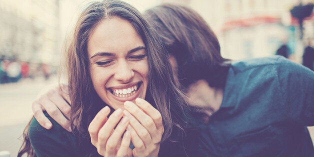 Happy young couple having fun at urban scene