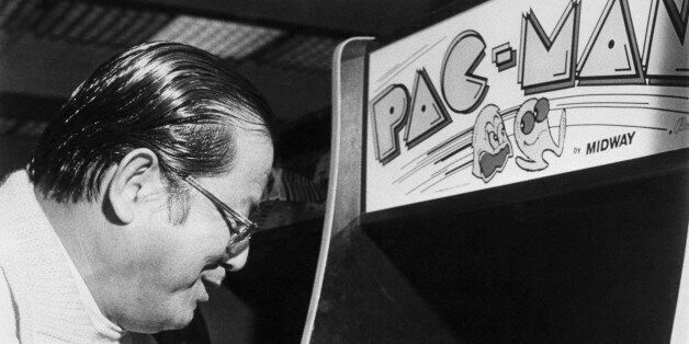 (Original Caption) Masaya Nakamura, father of the popular video arcade game, takes a turn at Pac-Man. He's happy about the global success of his creation, but a 'little concerned about the way some young people play so much.'