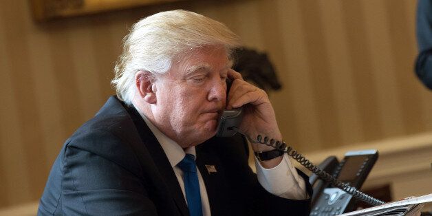WASHINGTON, DC - JANUARY 28: President Donald Trump speaks on the phone with Russian President Vladimir Putin in the Oval Office of the White House, January 28, 2017 in Washington, DC. On Saturday, President Trump is making several phone calls with world leaders from Japan, Germany, Russia, France and Australia. (Photo by Drew Angerer/Getty Images)
