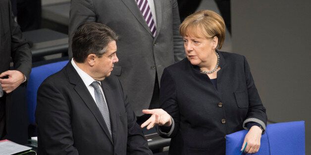 BERLIN, GERMANY - JANUARY 19: German Chancellor Angela Merkel and German Economy Minister Sigmar Gabriel talk before a commemoration at Bundestag on January 19, 2017 in Berlin, Germany.On December 19, 2016 Anis Amri, a Tunisian radical, drove a heavy truck into a crowded Christmas market at Breitscheidplatz, killing 12 people and injured 50. (Photo by Steffi Loos/Getty Images)
