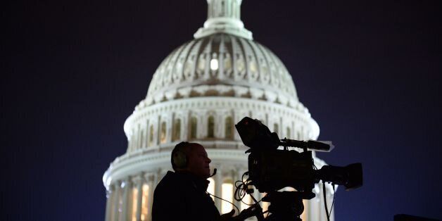 The US Capitol Building is pictured as media gather on January 20, 2017 in Washington, DC. Donald Trump will be sworn in as the 45th president of the United States Friday -- capping his improbable journey to the White House and beginning a four-year term that promises to shake up Washington and the world. / AFP / Robyn Beck (Photo credit should read ROBYN BECK/AFP/Getty Images)
