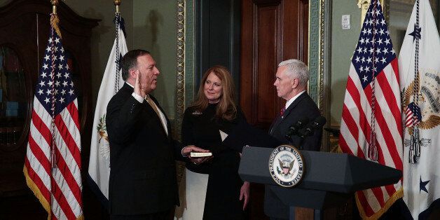 WASHINGTON, DC - JANUARY 23: Mike Pompeo (L) is sworn in as CIA Director by Vice President Mike Pence (R) as wife Susan Pompeo (2nd L) looks on at Eisenhower Executive Office Building January 23, 2017 in Washington, DC. Pompeo was confirmed for the position by the Senate this evening. (Photo by Alex Wong/Getty Images)