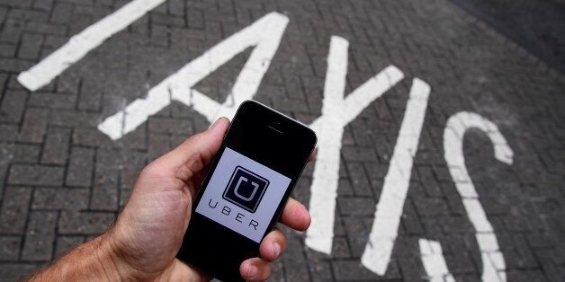 A photo illustration shows the Uber app logo displayed on a mobile telephone, as it is held up for a posed photograph in central London, Britain October 28, 2016. REUTERS/Toby Melville/Illustration