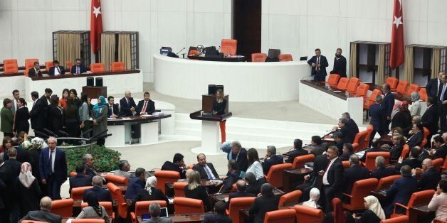 A general view shows deputies attending a session of parliament as Turkish deputy Aylin Nazliaka (C) has handcuffed herself to the podium in a protest against the constitutional reform aimed at strengthening the powers of the Turkish president during a debate at the Turkish Parliament in Ankara on January 19, 2017.The proposed changes which will create an executive presidency for the first time in modern Turkey, are controversial and far-reaching, with Human Rights Watch (HRW) claiming they would 'weaken parliamentary oversight of the executive'. / AFP / Adem ALTAN (Photo credit should read ADEM ALTAN/AFP/Getty Images)